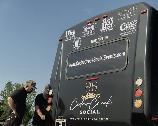Cedar Creek Social bus with its business branding and team members visible