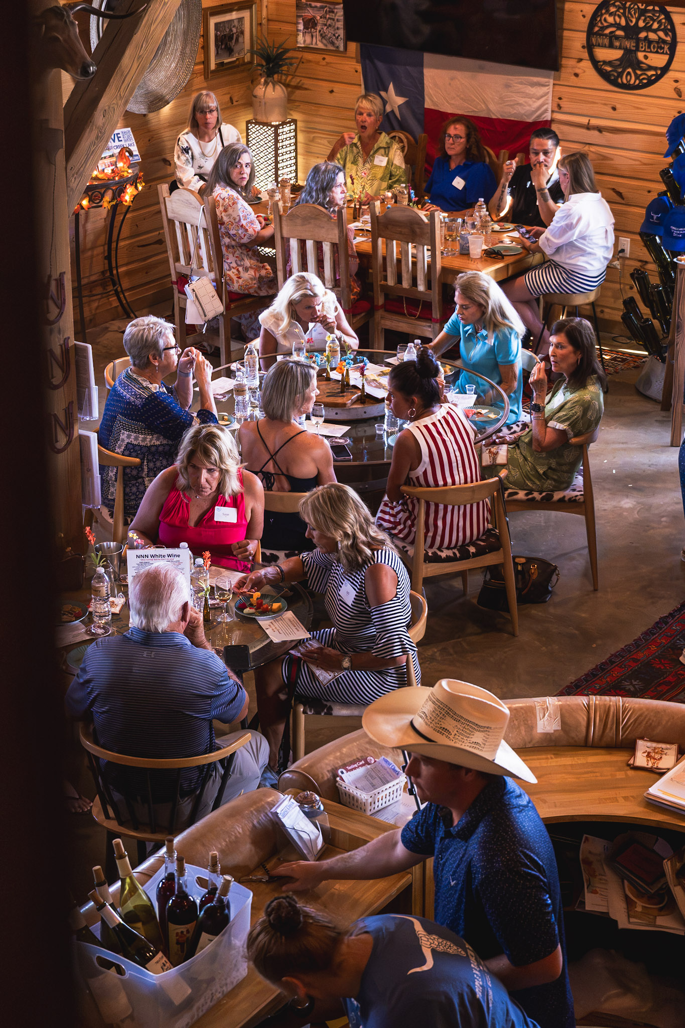 Guests gathered around tables at a winery event