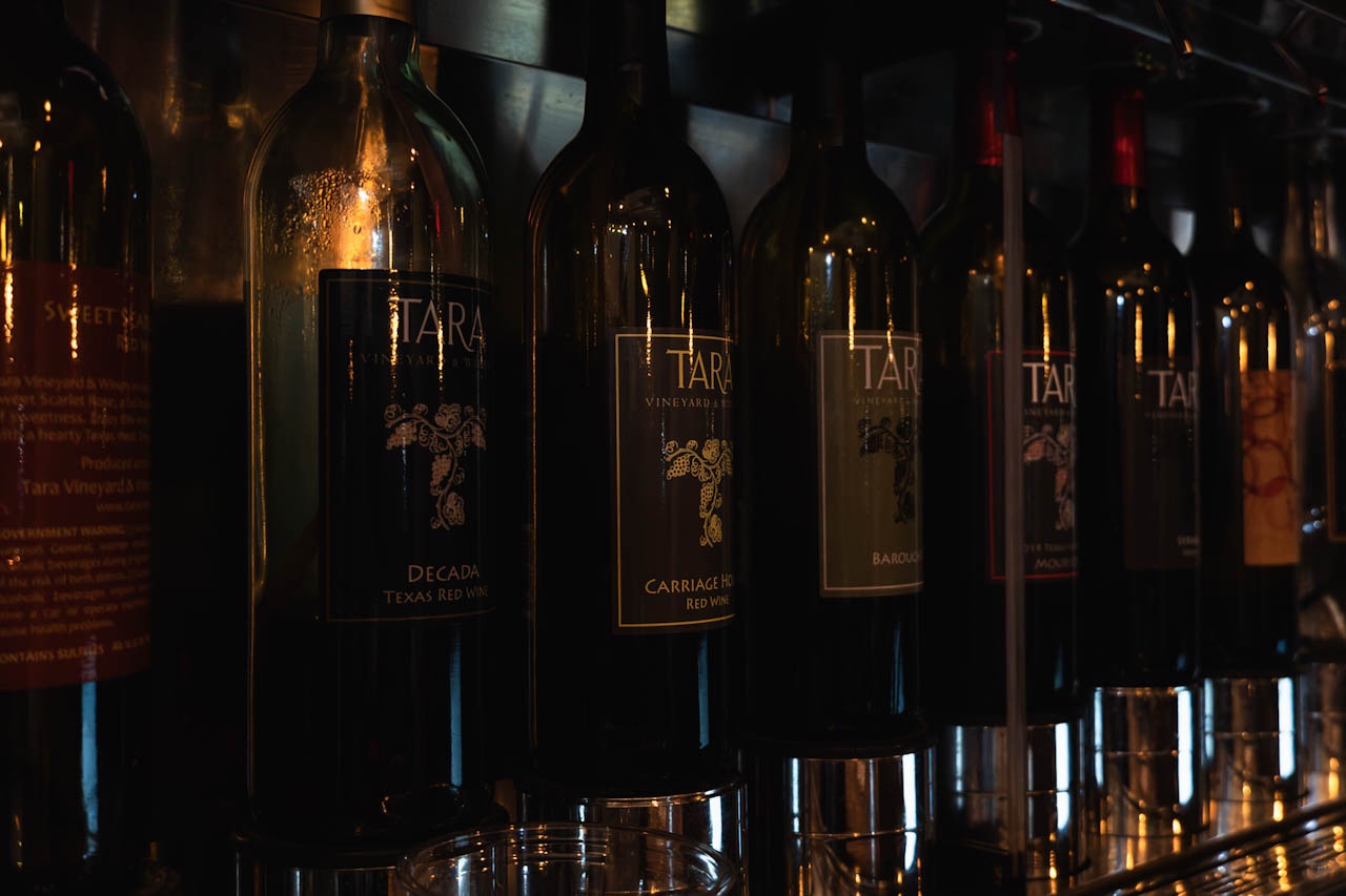Wine bottles catching warm light at a Texas winery